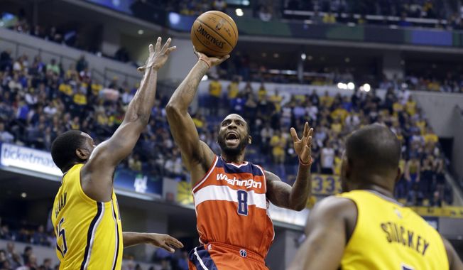 Washington Wizards forward Rasual Butler (8) shoots between Indiana Pacers guard Donald Sloan (15) and guard Rodney Stuckey (2) during the first half of an NBA basketball game in Indianapolis, Tuesday, April 14, 2015. (AP Photo/Michael Conroy) **FILE**