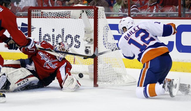 New York Islanders left wing Josh Bailey (12) scores a goal past Washington Capitals goalie Braden Holtby during the second period of Game 1 in a first-round NHL hockey Stanley Cup playoffs series, Wednesday, April 15, 2015, in Washington. (AP Photo/Alex Brandon)