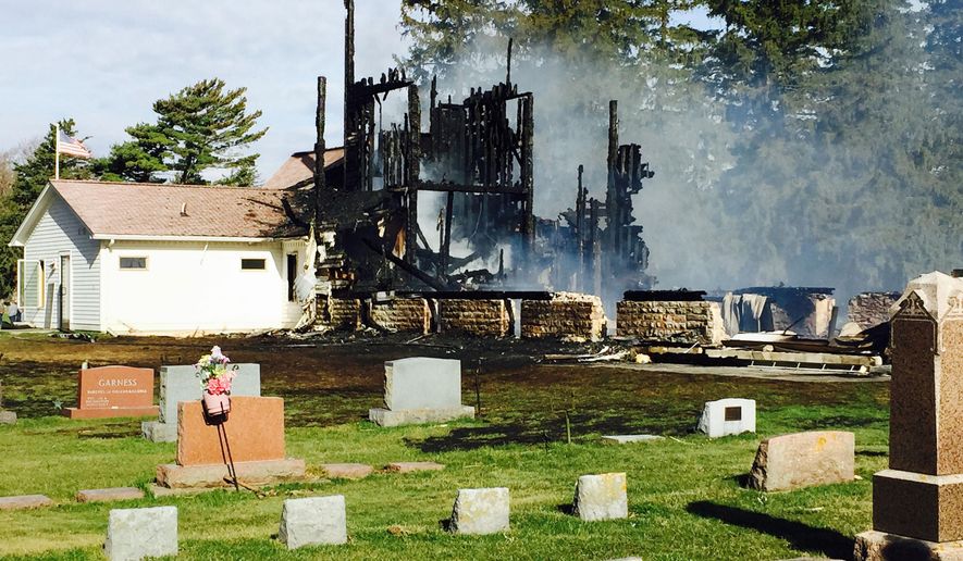 Authorities investigate the scene of a fire at the Henrytown Lutheran Church, Thursday, April 16, 2015, in Canton, Minn. Congregation member Doris McCabe said the church was built in the late 1800s, The Post-Bulletin reported. (Jerry Olson/The Rochester Post-Bulletin via AP)