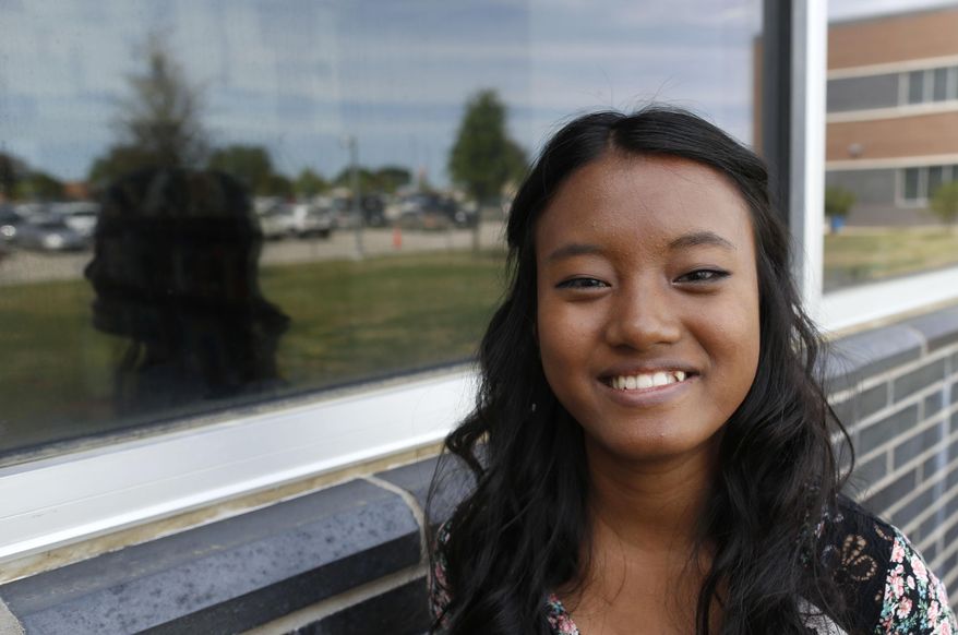 Van Par Zi poses for a portrait at Lewisville High School in Lewisville, Texas, Friday, April 10, 2015. Zi, who came to the US nearly 11 years ago, is headed to Abilene Christian University to study pre-med. (Vernon Bryant/The Dallas Morning News via AP)