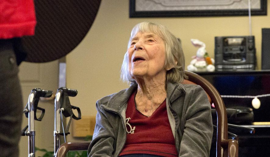 In this photo taken on Monday, April 6, 2015, resident Ruth Smith sings along during music therapy at Amber Way of the Heritage Community in Kalamazoo, Mich. The goal of the music therapy program at Amber Way is to work on memory recall through hearing songs the residents know, peer to peer interaction by trading instruments and fine and gross motor skills by playing percussion instruments and doing stretches. (AP Photo/Kalamazoo Gazette-MLive Media Group, Crystal Vander Weit ) ALL LOCAL TELEVISION OUT; LOCAL TELEVISION INTERNET OUT