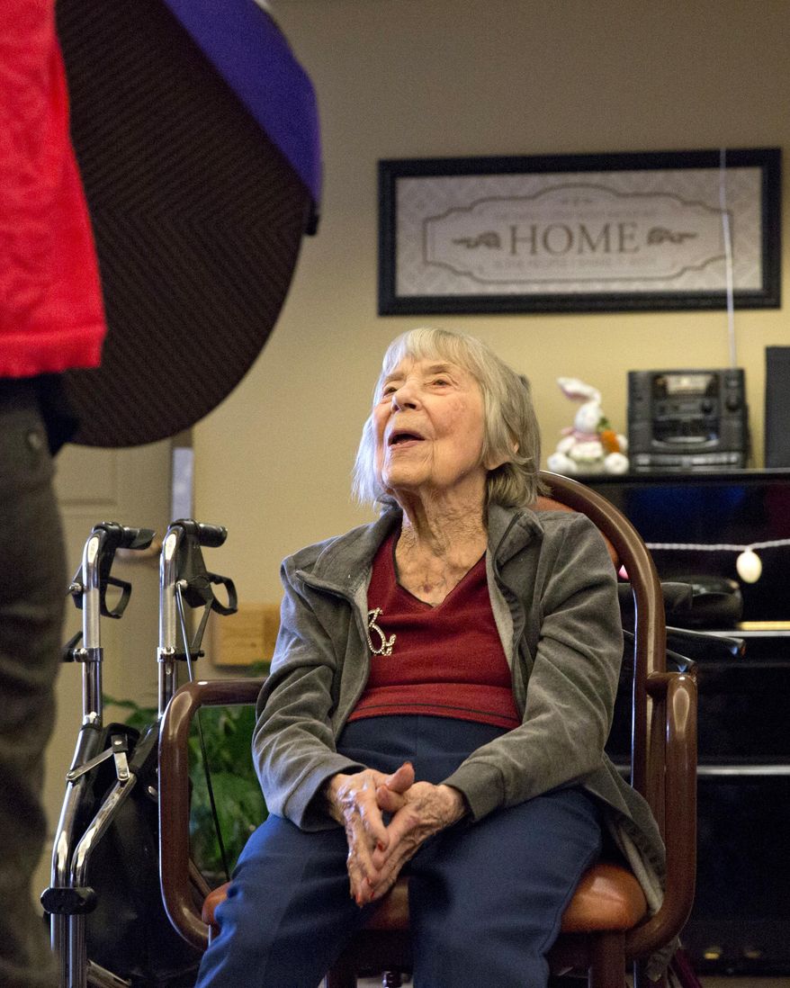 In this photo taken on Monday, April 6, 2015, resident Ruth Smith sings along during music therapy at Amber Way of the Heritage Community in Kalamazoo, Mich. The goal of the music therapy program at Amber Way is to work on memory recall through hearing songs the residents know, peer to peer interaction by trading instruments and fine and gross motor skills by playing percussion instruments and doing stretches. (AP Photo/Kalamazoo Gazette-MLive Media Group, Crystal Vander Weit ) ALL LOCAL TELEVISION OUT; LOCAL TELEVISION INTERNET OUT