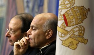 In this Nov. 12, 2012 file photo, Archbishop Salvatore Cordileone, of San Francisco, center, and Archbishop William Lori, of Baltimore, listen to a speaker during the United States Conference of Catholic Bishops&#39; annual fall meeting in Baltimore. Local Catholics have gone public with their complaints about the San Francisco archbishop. On Thursday, April 16, 2015, an advertisement in the San Francisco Chronicle shows more than 100 Catholics have signed a full-page newspaper advertisement asking Pope Francis to remove Cordileone. (AP Photo/Patrick Semansky/File)