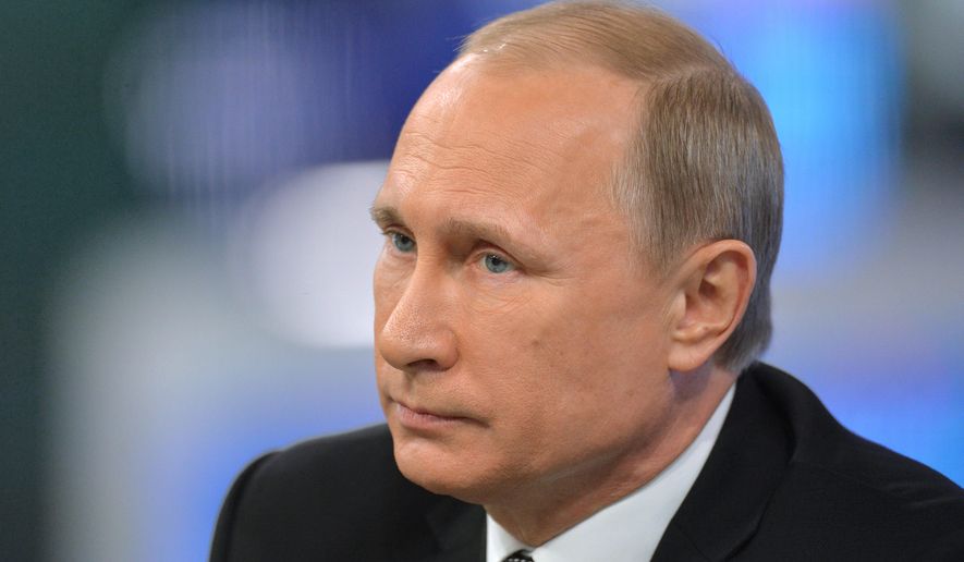 Russian President Vladimir Putin listens during an annual call-in show on Russian television "Conversation With Vladimir Putin" in Moscow, Russia, Thursday, April 16, 2015. Speaking Thursday in a televised call-in show with the nation, Putin said the nation's economic performance has remained strong, despite Western sanctions slapped on Russia over the Ukrainian crisis and a slump in global oil prices. (Alexei Druzhinin, RIA Novosti, Presidential Press Service via AP)