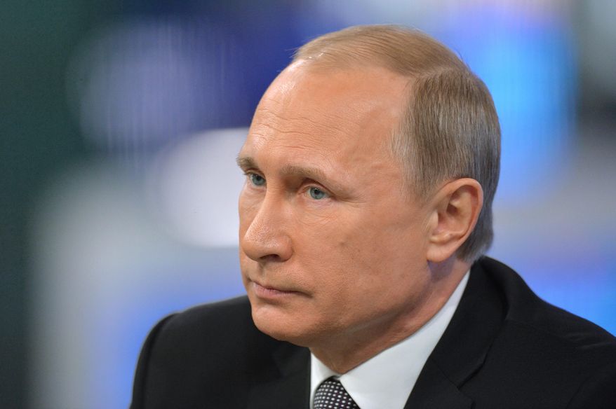 Russian President Vladimir Putin listens during an annual call-in show on Russian television "Conversation With Vladimir Putin" in Moscow, Russia, Thursday, April 16, 2015. Speaking Thursday in a televised call-in show with the nation, Putin said the nation's economic performance has remained strong, despite Western sanctions slapped on Russia over the Ukrainian crisis and a slump in global oil prices. (Alexei Druzhinin, RIA Novosti, Presidential Press Service via AP)