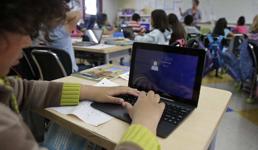 In this Thursday, March 12, 2015 photo, a fourth-grader logs onto an ASUS tablet to use Google docs to complete an exercise at Mira Vista School in Richmond, Calif. (AP Photo/Eric Risberg)