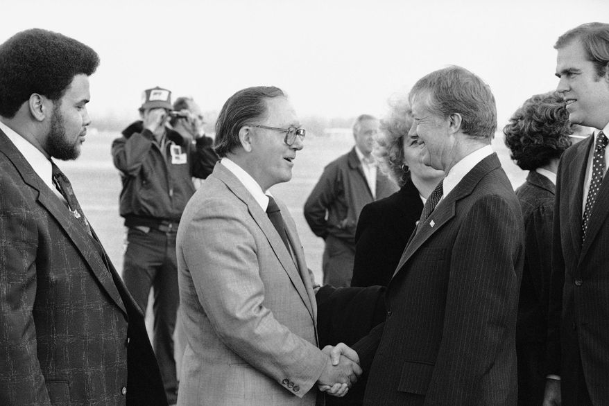 FILE - In this Nov. 2, 1978 file photo, U.S. Sen. Robert Griffin, left, greets President Jimmy Carter in Flint, Mich. Griffin, a Michigan Republican whose withdrawal of support hastened President Richard Nixon’s resignation during the Watergate scandal, has died at age 91. His death was confirmed Friday, April 17, 2015 by Reynolds Jonkhoff funeral home in Traverse City, though no other details were immediately released. (AP Photo/Dennis Cook, File)