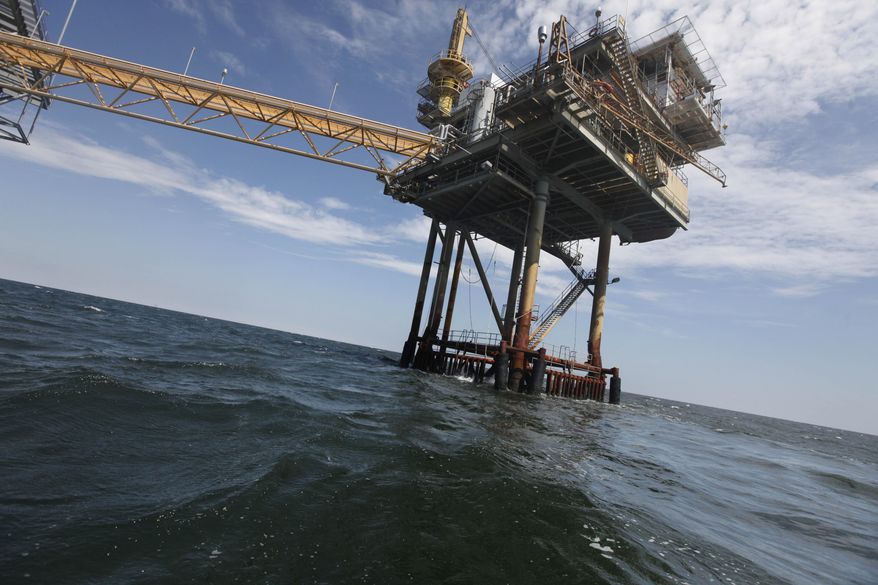 FILE - This April 27, 2010 file photo shows an oil rig in the Gulf of Mexico near the Chandeleur Islands, off the Southeastern tip of Louisiana. From above, five years after the BP well explosion, the Gulf of Mexico looks clean, green and whole again, teeming with life: a testament to the resilience of nature. But there's more than surface shimmering blue and emerald to the aftermath of the Deepwater Horizon spill. And it's not nearly as pretty a picture, nor as clear. (AP Photo/Gerald Herbert, File)