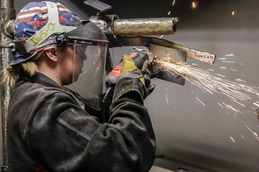 In this March 6, 2015 photo, Illinois Welding School student Courtney Clark works during class in Romeoville Ill. Educational institutions, such as the Illinois Welding School, are filling up to satisfy an increased demand for welders as the baby boomer generation retires, and along with it, longtime skilled workers. (Lathan Goumas/The Herald-News via AP)