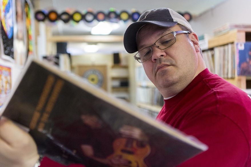 Scott Reed shops for records at Backtrack Records on Saturday, April 4, 2015 in Lincoln, Neb. Since the store's opening in January, Reed has been a frequent customer. Recycled Sounds will be one of three independent record stores in Lincoln participating in Record Store Day. (Allison Hess/The Journal-Star via AP) LOCAL TELEVISION OUT; KOLN-TV OUT; KGIN-TV OUT; KLKN-TV OUT