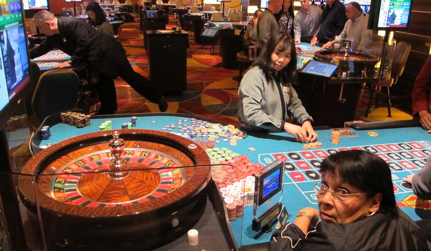 This April 17, 2015 photo shows a roulette dealer counting out chips in a newly renovated section of the casino floor at the Tropicana Casino and Resort in Atlantic City, N.J. The casino is nearing completion of a $50 million renovation. (AP Photo/Wayne Parry)