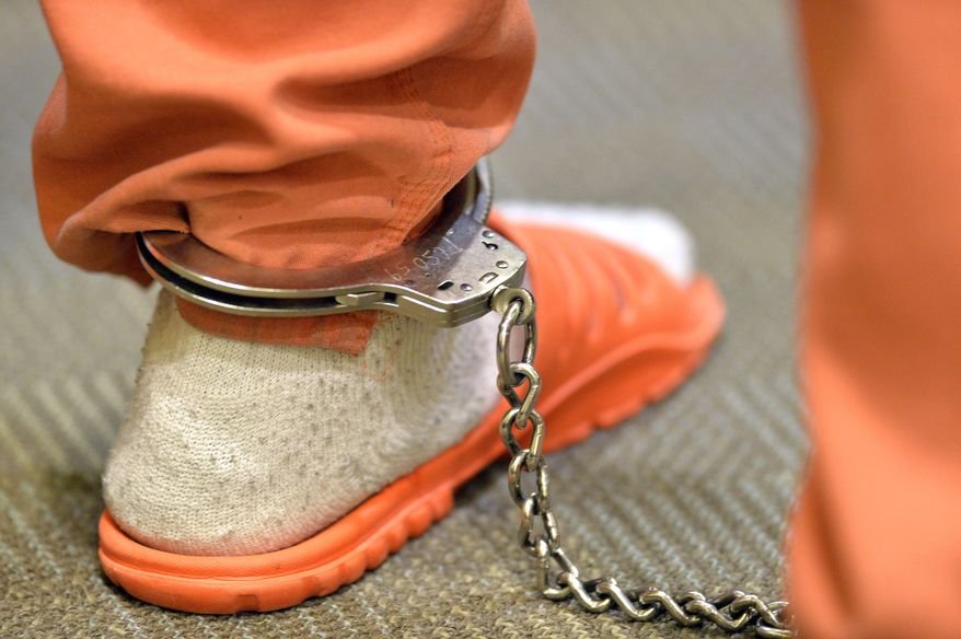 A prisoner in ankle chains appears before Judge David A.Tapp as he is evaluated for his willingness to participate in the Supervision Motivation Accountable Responsibility and Treatment program, also known as SMART probation at the Pulaski County Courthouse in Somerset, Ky., Thursday, April 9, 2015. A handful of addicts are participating in a special probation program overseen by Judge Tapp that provides medication under the brand name Vivitrol that blocks the opioid receptors in the brain. It means opioids like prescription painkillers and heroin would have no effect on addicts, which would help them stop using the drugs. (AP Photo/Timothy D. Easley)