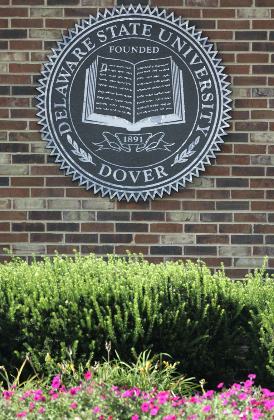 FILE - A sign posted at the front gate of Delaware State University in Dover, Del., is seen in this Friday, Sept., 21, 2007 file photo. Three people were shot and injured Saturday night April 18, 2015 at a cookout on the Delaware State University campus, officials said, and authorities are searching for the shooter. The injuries were not life-threatening. (AP Photo/Carolyn Kaster, File)