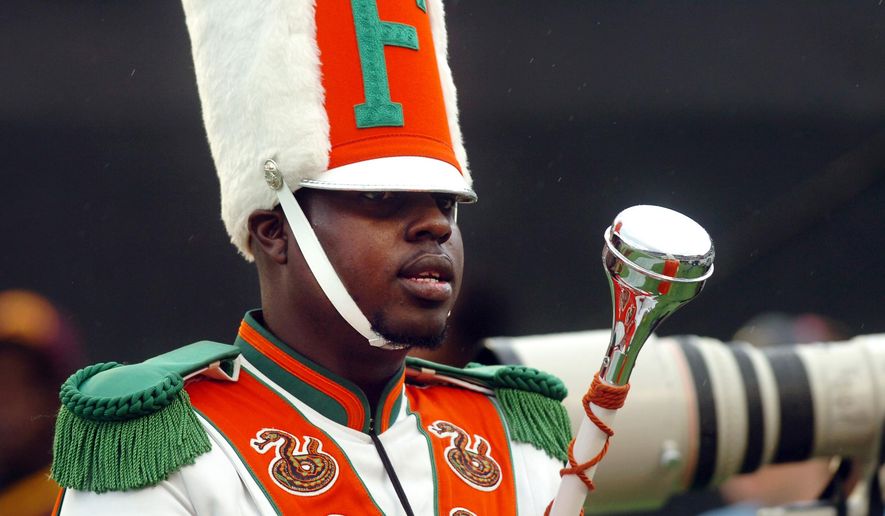 FILE - In this Saturday, Nov. 19, 2011 file photo, Robert Champion, a drum major in Florida A&M University's Marching 100 band, performs during halftime of a football game in Orlando, Fla. On Monday, April 20, 2015, the final three former band members charged with manslaughter and felony hazing in Florida A&M University drum major Robert Champion’s beating death following a football game will go on trial for the November 2011 attack. (AP Photo/The Tampa Tribune, Joseph Brown III, File) MANDATORY CREDIT, MAGS OUT, ST. PETE, LAKELAND, BRADENTON OUT