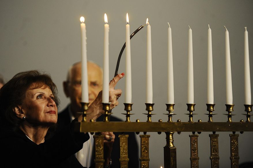 A fourth candle is lit in memory of Rabbis, teachers and scholars who were murdered during the Holocaust, during a Tom HaShoah Commemoration Day at the Michigan Holocaust Museum in Farmington Hills, Mich., Sunday, April 19, 2015. The annual event at the center was a day set aside to remember the approximately six million Jews killed by Nazis during World War II. (Elizabeth Conley/Detroit News via AP) DETROIT FREE PRESS OUT; HUFFINGTON POST OUT