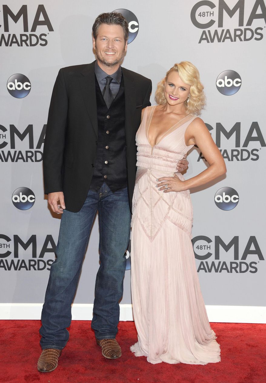 File-This Nov. 5, 2014, file photo shows Blake Shelton, left, and Miranda Lambert arriving at the 48th annual CMA Awards at the Bridgestone Arena in Nashville, Tenn. Shelton may be going into Academy Country of Music Awards as a host, performer and two-time nominee, but he has another priority: being a cheerleader. Shelton’s wife, fiery country star, Lambert, is the top contender with eight nominations, including the coveted entertainer of the year, an award she has yet to win.(Photo by Evan Agostini/Invision/AP, File)