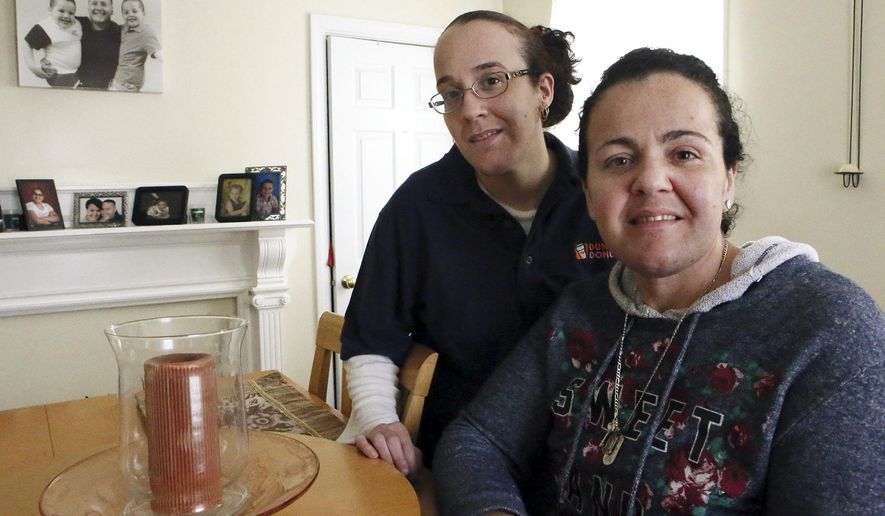ADVANCE FOR USE SATURDAY, APRIL 18, 2015, AND THEREAFTER- In this March 26, 2015, photo, Susane Nunes, left, poses for a photo with her sister Dee Noonan in New Bedford, Mass. The sisters opted to have preventative surgeries because of their risk of breast cancer. (Mike Valeri/Standard Times via AP)