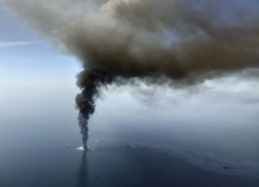 FILE - In this April 21, 2010 file photo by Gerald Herbert, the Deepwater Horizon oil rig burns in the Gulf of Mexico. Rig fires happen with some regularity, but when word came that the rig was listing badly after an explosion the night before, New Orleans-based Herbert raced to a small airport and grabbed the first helicopter pilot he could find. Together with a photographer from the Times-Picayune newspaper, the three headed out in a four-seat helicopter with only enough fuel to get to the site and shoot for a few minutes. "You could see it for miles," Herbert recalled. The smoke "started appearing through the haze as a thick blob,” he said. "As we got closer, we realized how immense it was. The smoke was actually higher than us, and we were circling around it trying to avoid it." Hovering at 4,000 feet _ the lowest authorities would allow them to fly _ the three were struck by the scale of the unfolding disaster. "The enormity of it did not escape us, because you could see that what looked like a tiny little burning ember was a massive oil platform. You could see oil in the water," Herbert said. The images were the first from what would become the nation’s worst offshore spill. The rig would sink within three days of exploding, and the oil would flow unchecked for nearly three months. (AP Photo/Gerald Herbert, File)