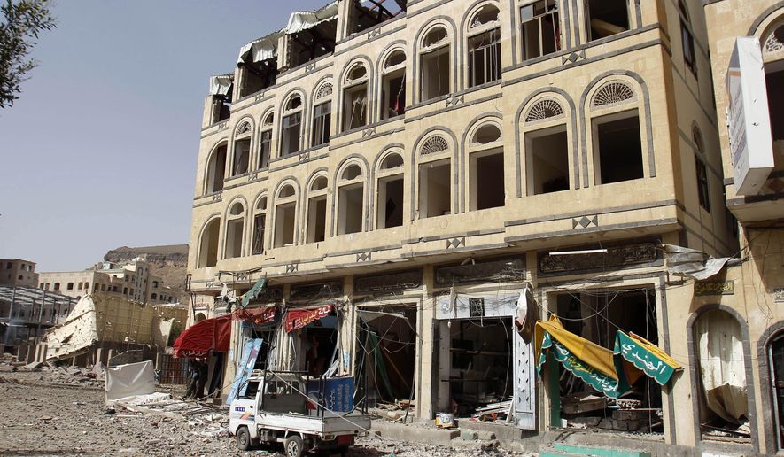 A street is littered with debris after a Saudi-led airstrike against Iran-allied Shiite rebels, known as Houthis, hit a site of a weapons cache in Yemen's capital, Monday, April 20, 2015. Airstrikes on weapons caches in Yemen's rebel-held capital on Monday caused massive explosions that shattered windows, sent residents scrambling for shelter and killed a local TV presenter. (AP Photo/Hani Mohammed)