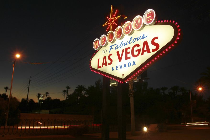 File - In this Oct. 4, 2012, file photo, the "Welcome to Fabulous Las Vegas" neon sign is outlined in pink lightbulbs in honor of breast cancer awareness month in Las Vegas. Betty Willis, the woman who designed the iconic neon sign that has welcomed countless visitors to Las Vegas since 1959 has died. She was 91. (Sam Morris/Las Vegas Sun via AP, File)