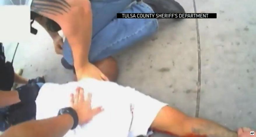 FILE - In this file screen shot from April 2, 2015 video provided by the Tulsa County Sheriff's Office, police restrain 44-year-old Eric Harris after he was chased down and tackled by a Tulsa County Deputy, and then shot by a reserve sheriff's deputy while in custody, in Tulsa, Okla. The sheriff's office said 73-year-old reserve deputy Robert Charles Bates fired the shot that killed Harris, believing he was using his stun gun instead of his service weapon when he opened fire. (Tulsa County Sheriff's Office via AP, File)