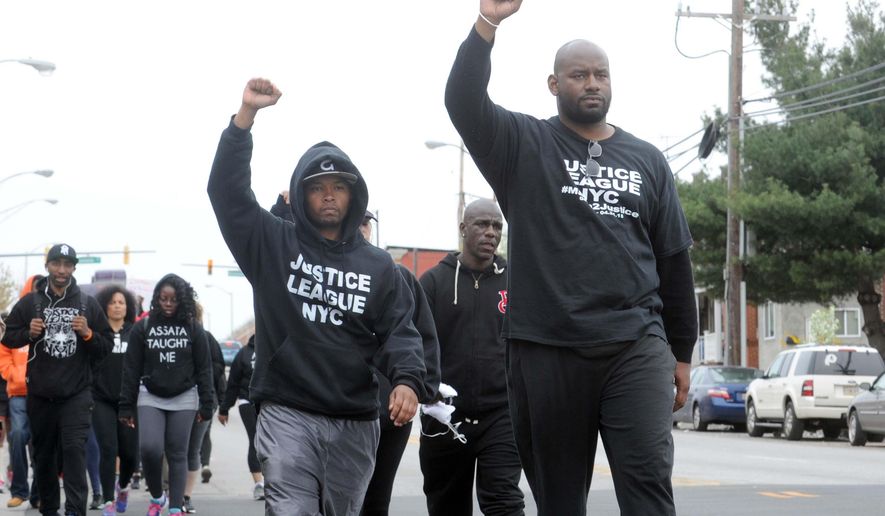 Citizens and groups such as the Justice League of NYC protest against the police following the death of Freddie Gray, Sunday, April 19, 2015, in Baltimore. Gray, 25, of Baltimore, died Sunday at a hospital, a week after he was hurt following an arrest. (Algerina Perna/The Baltimore Sun via AP) WASHINGTON EXAMINER OUT