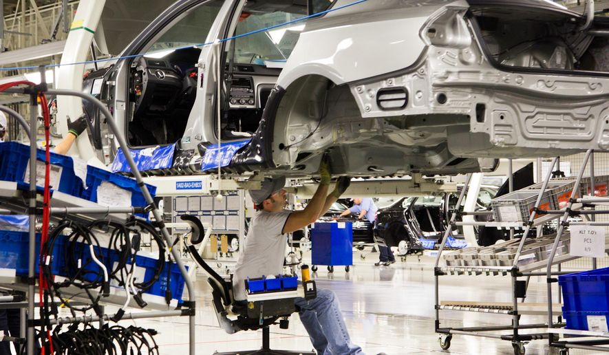 FILE - In this July 31, 2012, file photo, an employee works on a Passat sedan at the Volkswagen plant in Chattanooga, Tenn. Lured by low wages and tax-saving free trade agreements, auto companies from the U.S. and overseas are accelerating plans to build new factories and add jobs in Mexico. The moves, part of a decade-long trend, are luring investments and work that could have gone to the U.S. and Canada, according to experts. But they also are likely to keep car and truck prices in check even as automakers add expensive fuel-saving features to meet U.S. gas mileage requirements. (AP Photo/Erik Schelzig, File)