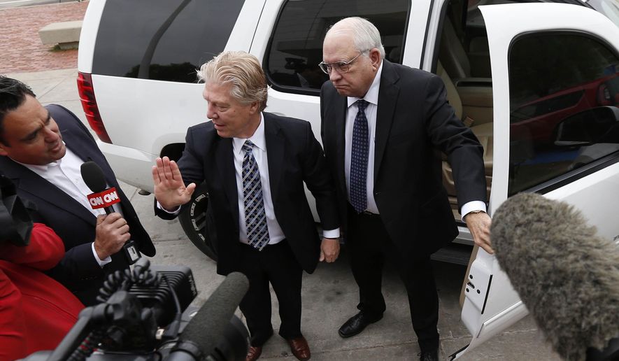 FILE - In this April 14, 2015 file photo, volunteer sheriff's deputy Robert Bates, right, arrives at the Tulsa County Jail with his attorney, Clark Brewster, in Tulsa, Okla. Bates,who killed an unarmed suspect in Tulsa, apologized for the shooting but described the confusion as a common problem in law enforcement. Experts agree that this is a real but very rare phenomenon that probably happens less than once a year nationwide. (Matt Barnard/Tulsa World via AP, File)