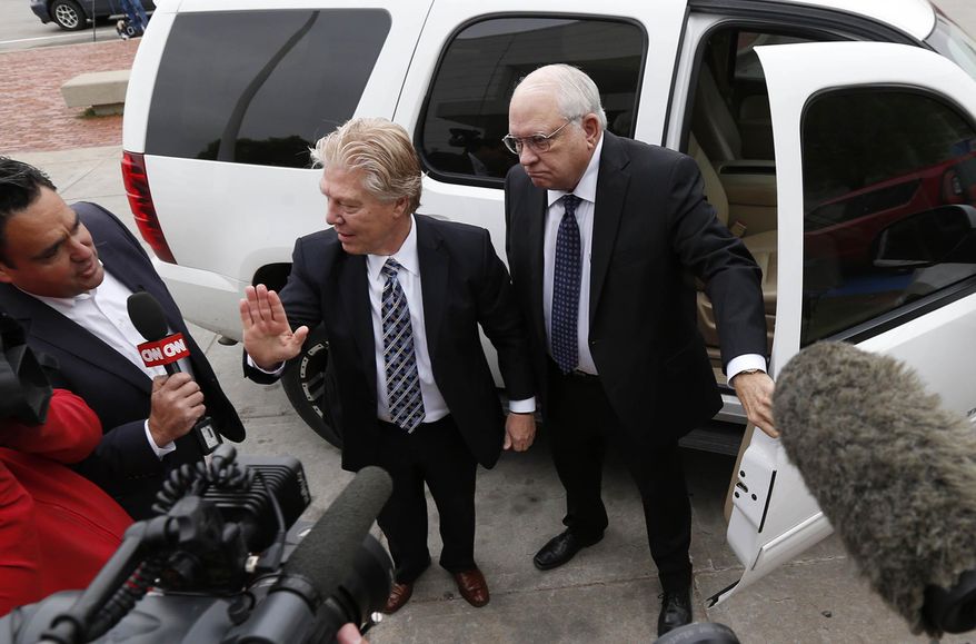 FILE - In this April 14, 2015 file photo, volunteer sheriff's deputy Robert Bates, right, arrives at the Tulsa County Jail with his attorney, Clark Brewster, in Tulsa, Okla. Bates,who killed an unarmed suspect in Tulsa, apologized for the shooting but described the confusion as a common problem in law enforcement. Experts agree that this is a real but very rare phenomenon that probably happens less than once a year nationwide. (Matt Barnard/Tulsa World via AP, File)