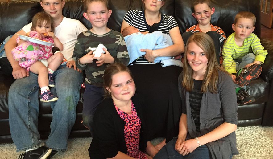 This April 19, 2015 photo provided by Tami Richardson shows Niki Rogan, holding Blaise, with her children: Anne, 15; John 13; Claire, 11; Ben, 9; Luke, 7; Jacob, 4 and Gemma, 2, in Wausau, Wis. Donations continue to climb for the family of eight children whose father was killed last Friday when a deer stuck their van windshield as he was driving his pregnant wife and children to the hospital for the birth of their eighth child. All were taken to a hospital where Michael Rogan was pronounced dead. His wife gave birth to a healthy boy hours later. Niki and the children suffered minor injuries. (Tami Richardson via AP)