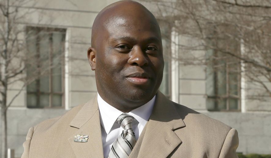 In this photo taken Jan.13, 2014, Little Rock School District superintendent Dexter Suggs walks from the Federal Courthouse in Little Rock, Ark., during a break in a hearing dealing with desegregation issues. Suggs resigned Tuesday, April 21, 2015, amid plagiarism questions involving his 2009 doctoral dissertation. (AP Photo/Danny Johnston)