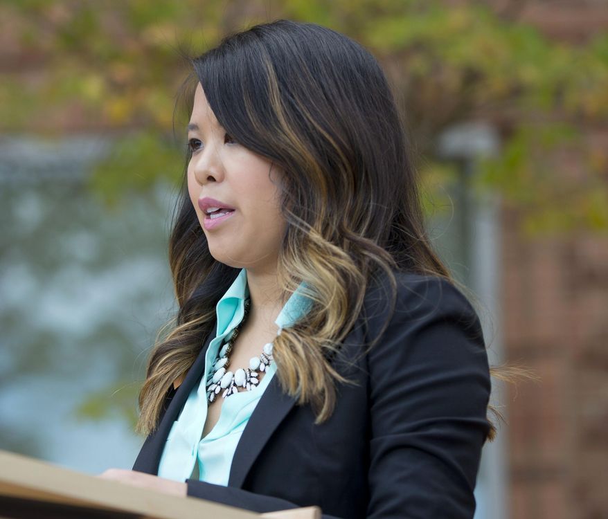 FILE - In this Oct. 24, 2014, file photo, Patient Nina Pham speaks outside of National Institutes of Health (NIH) in Bethesda, Md. A Texas district judge on Monday, April 20, 2015, put on hold a hospital operator's efforts to seek a worker's compensation claim for Pham who contracted Ebola while caring for the first U.S. patient to succumb to the deadly disease. (AP Photo/Pablo Martinez Monsivais, File)