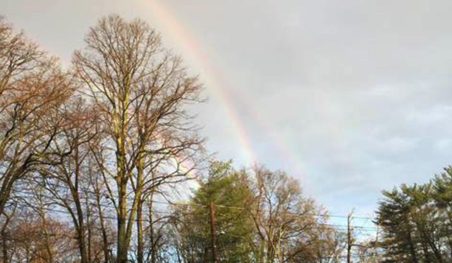 In this photo provided by Amanda Curtis, rainbows appear in the sky at a Glen Cove train station Tuesday, April 21, 2015, on Long Island in New York. Many are calling it a quadruple rainbow, but it’s not, said Raymond Lee, a professor of meteorology at the U.S. Naval Academy. He said they are reflections off of a water body, when the light bounces off a bay and then heads back through the droplets again. (Amanda Curtis via AP)