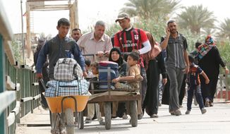 Displaced people from Ramadi cross the Bzebiz bridge heading towards Ramadi as they return to their homes, in Ramadi, 65 km west of Baghdad, Iraq, Tuesday, April 21, 2015. A United Nations humanitarian agency says more than 90,000 people have fled the Islamic State group&#39;s advance in Iraq&#39;s western Anbar province, which has set off fierce fighting in and around the provincial capital Ramadi. (AP Photo/Hadi Mizban)