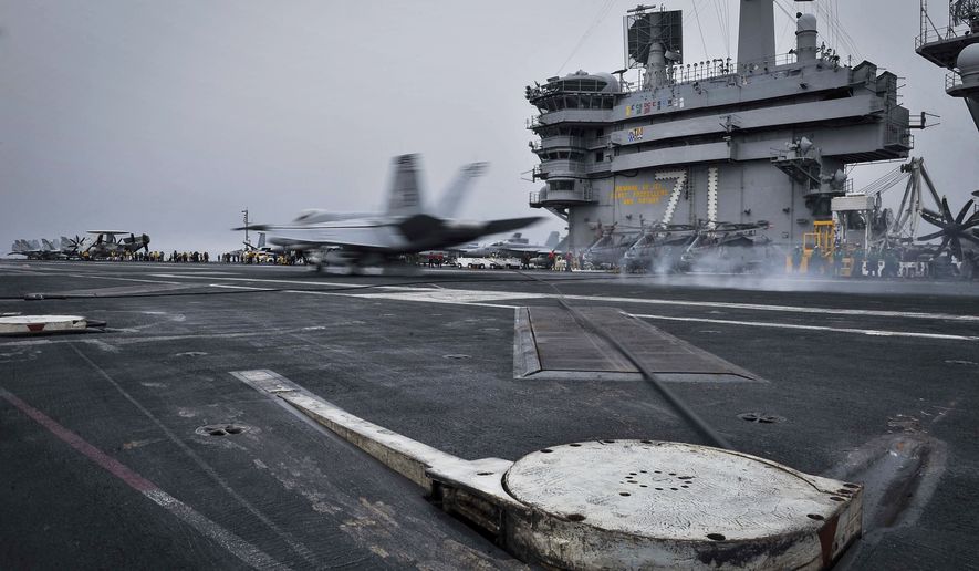 In this Wednesday, April 15, 2015, file image released by U.S. Navy Media Content Services, an F/A-18E Super Hornet, assigned to the Knighthawks of Strike Fighter Attack Squadron 136, lands on the flight deck aboard Nimitz-class aircraft carrier USS Theodore Roosevelt in the Fifth Fleet area of operations. The U.S. Navy has dispatched USS Theodore Roosevelt toward the waters off Yemen to join other American ships prepared to intercept any Iranian vessels carrying weapons to Houthi rebels, U.S. officials said on Monday.  (Mass Communication Specialist Seaman Anna Van Nuys/U.S. Navy Media Content Services via AP)