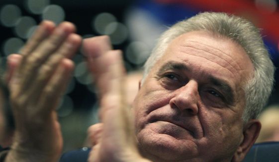 Tomislav Nikolic applauds during a pre-election rally in Belgrade, Serbia, in this May 15, 2012, file photo. (AP Photo/Darko Vojinovic)