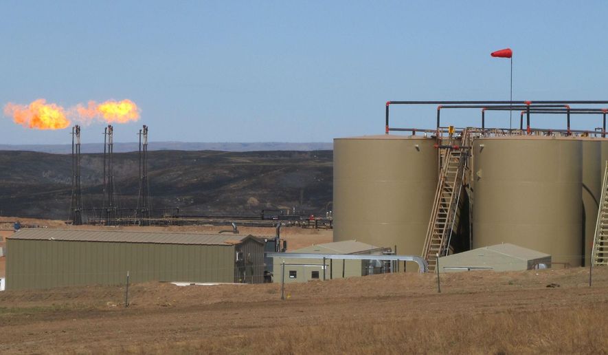 This Tuesday, April 21, 2015 photo shows the Whiting Petroleum facility in Keene, N.D. The energy company operating in the western North Dakota oil patch is offering help to ranchers affected by a grass fire started by gas flares at an oil well. The blaze earlier this month burned more than 4 ½ square miles in McKenzie County, damaging grazing land and destroying miles of fence line. Whiting Petroleum has met with the U.S. Forest Service and with ranchers to offer help, and is supplying a crew to repair fences, Acting District Ranger Scot Shuler said. (Lauren Donovan/The Bismarck Tribune via AP)