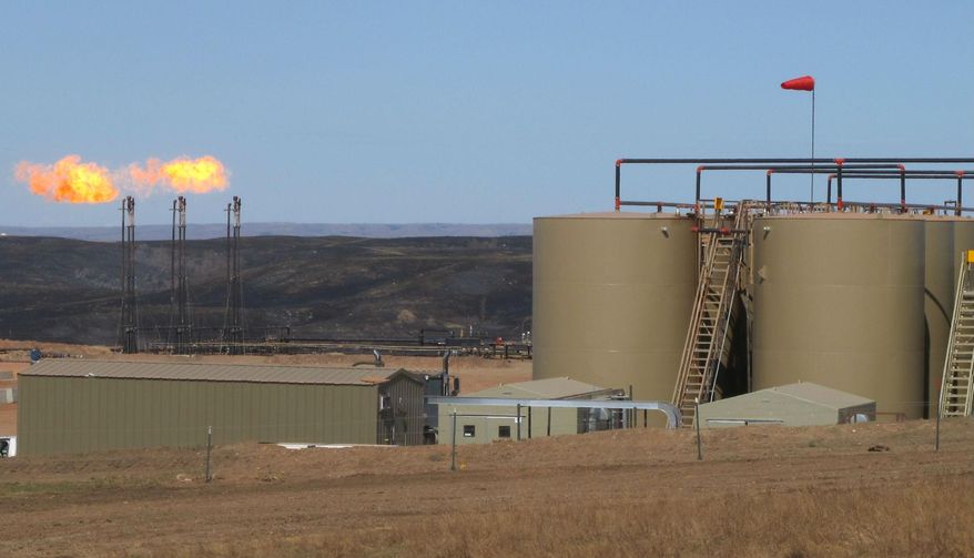 This Tuesday, April 21, 2015 photo shows the Whiting Petroleum facility in Keene, N.D. The energy company operating in the western North Dakota oil patch is offering help to ranchers affected by a grass fire started by gas flares at an oil well. The blaze earlier this month burned more than 4 ½ square miles in McKenzie County, damaging grazing land and destroying miles of fence line. Whiting Petroleum has met with the U.S. Forest Service and with ranchers to offer help, and is supplying a crew to repair fences, Acting District Ranger Scot Shuler said. (Lauren Donovan/The Bismarck Tribune via AP)
