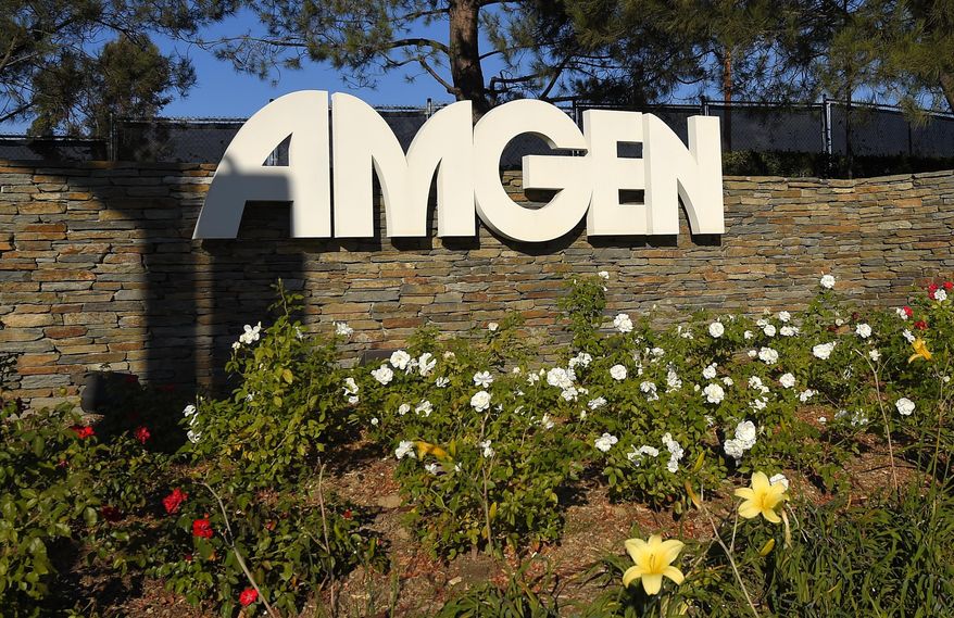 FILE - This Nov. 9, 2014 file photo shows signage at the entrance to Amgen offices in Thousand Oaks, Calif. Amgen Inc. boosted first-quarter profit by 51 percent, thanks to surging sales of its top prescription drugs and ongoing cost cuts designed to free up cash to mount an unprecedented spurt of new product launches. The huge biologic drugmaker on Tuesday, April 21, 2015, edged out Wall Street forecasts and boosted its profit forecast for 2015 a bit. (AP Photo/Mark J. Terrill, File)