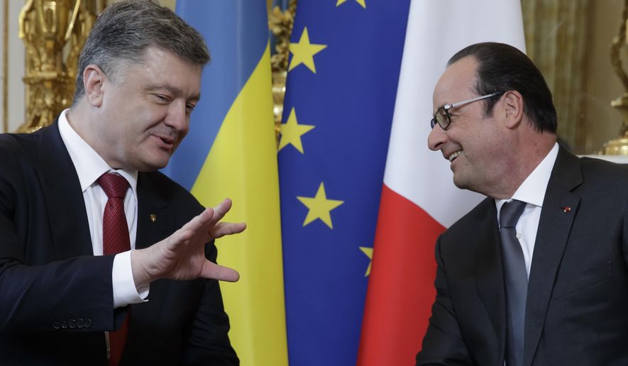 French President Francois Hollande, right, speaks with Ukraine's President Petro Poroshenko during a meeting at the Elysee Palace in Paris, France, Wednesday, April 22, 2015. Poroshenko is set to discuss current developments in Ukraine with his French counterpart. (AP Photo/Philippe Wojazer, Pool)