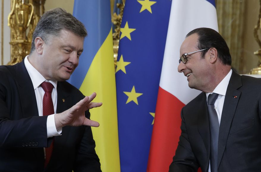 French President Francois Hollande, right, speaks with Ukraine's President Petro Poroshenko during a meeting at the Elysee Palace in Paris, France, Wednesday, April 22, 2015. Poroshenko is set to discuss current developments in Ukraine with his French counterpart. (AP Photo/Philippe Wojazer, Pool)
