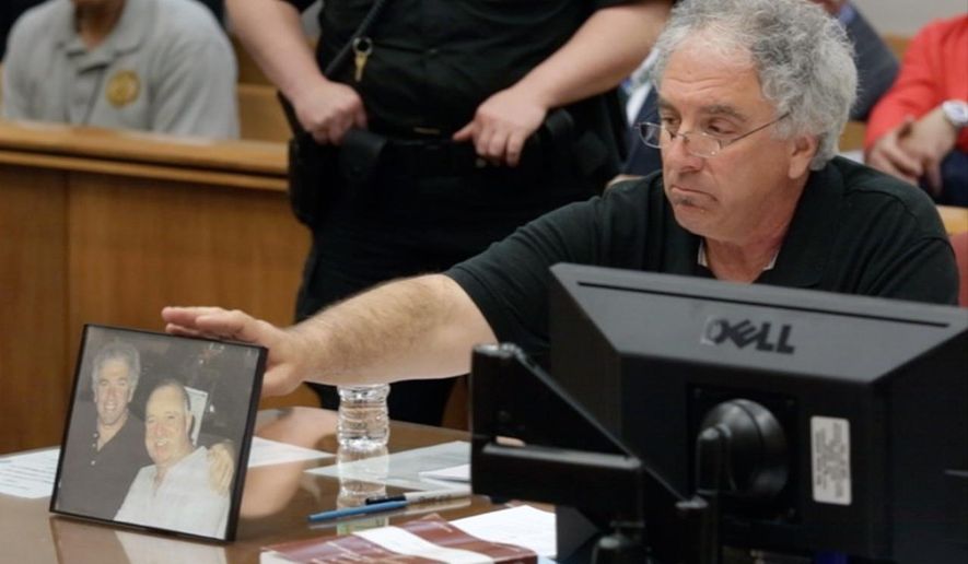 Raymond Wantorcik, brother of murder victim Danny Burroughs, refers to a photo of the pair stating "This is my best friend... I won't smile like that anymore" during the sentencing of Loretta Burroughs in N.J. Superior Court in Mays Landing, Wednesday April 22, 2015. Loretta Burroughs received a term of 55 years in prison for murder and other crimes in the killing of her husband Danny, whose dismembered remains she hid in plastic storage containers and took with her when she moved. (Michael Ein/The Press of Atlantic City via AP, Pool)