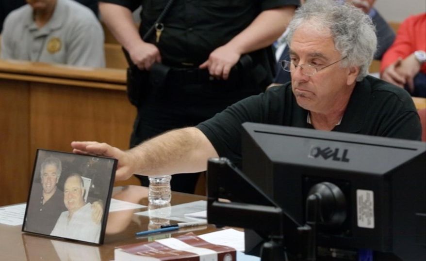 Raymond Wantorcik, brother of murder victim Danny Burroughs, refers to a photo of the pair stating "This is my best friend... I won't smile like that anymore" during the sentencing of Loretta Burroughs in N.J. Superior Court in Mays Landing, Wednesday April 22, 2015. Loretta Burroughs received a term of 55 years in prison for murder and other crimes in the killing of her husband Danny, whose dismembered remains she hid in plastic storage containers and took with her when she moved. (Michael Ein/The Press of Atlantic City via AP, Pool)