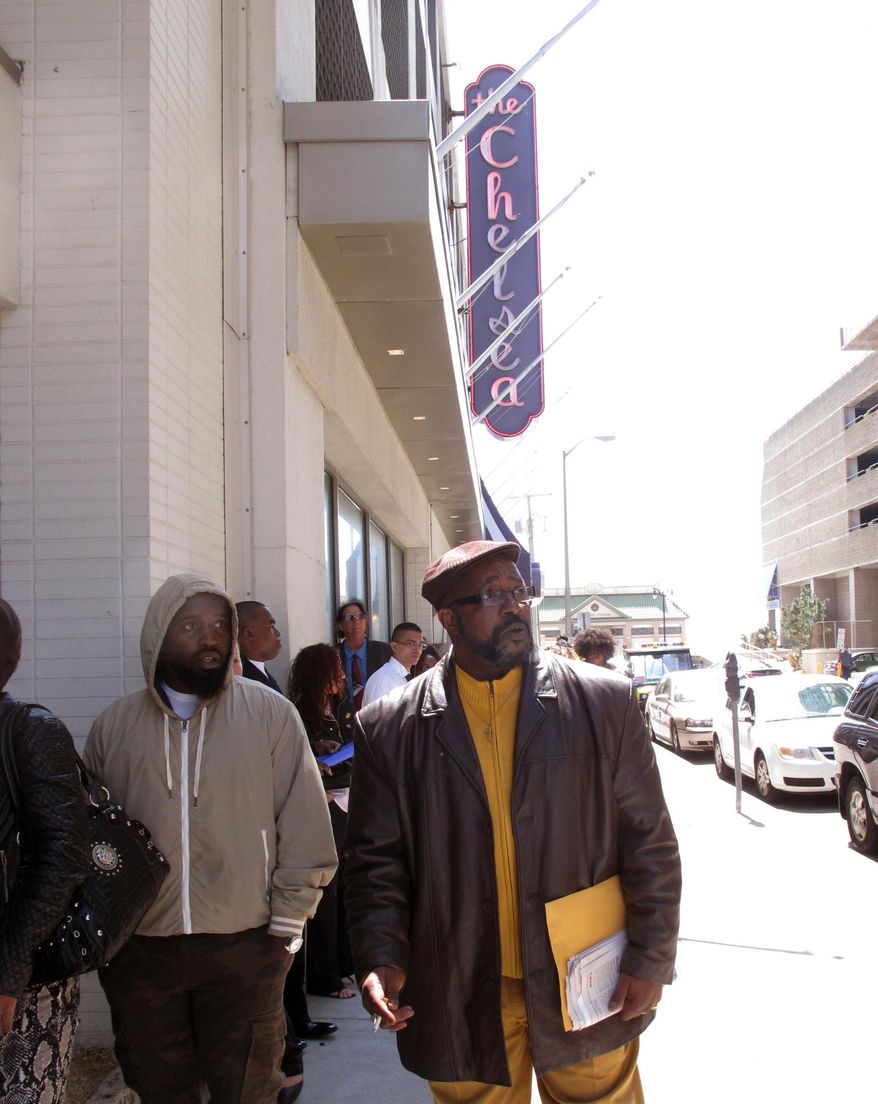 Ronald Roberts, right, waits at the head of the line of applicants for jobs at the Chelsea hotel in Atlantic City N.J. on Wednesday April 22, 2015. Roberts lost his cook's job last August when the Showboat casino closed. Many laid-off casino workers were among those seeking jobs at the Chelsea. Chelsea owner Curtis Bashaw said most of the positions are seasonal summer jobs, but added some of the best hires will be kept on permanently. (AP Photo/Wayne Parry)