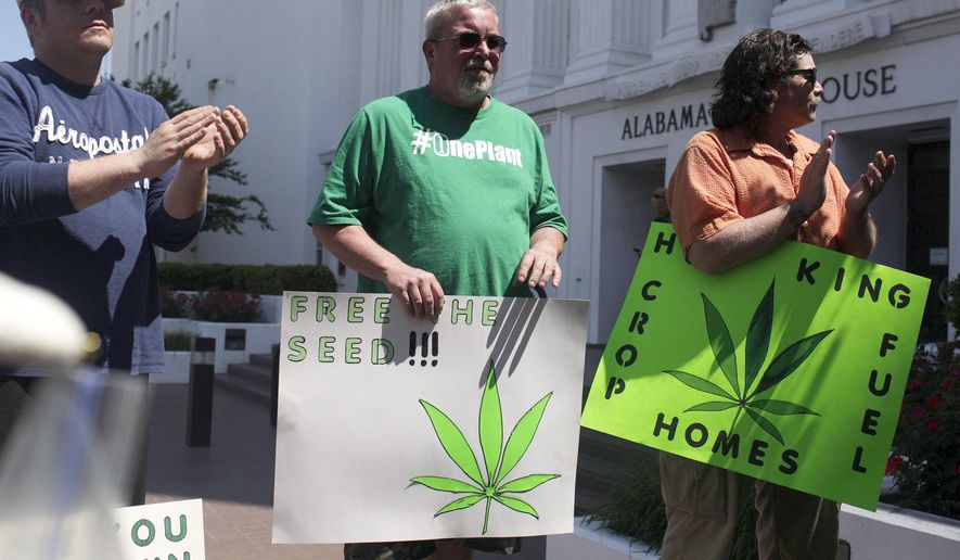 Residents of Alabama stand outside of the state house in favor of medicinal marijuana legalization at a rally, Wednesday, April 22, 2015, in Montgomery, Ala. The Senate Judiciary Committee will hear arguments for and against legalizing medicinal marijuana. The legislation would allow patients with certain medical conditions to buy and even grow a small amount of marijuana each month. (AP Photo/Brynn Anderson)