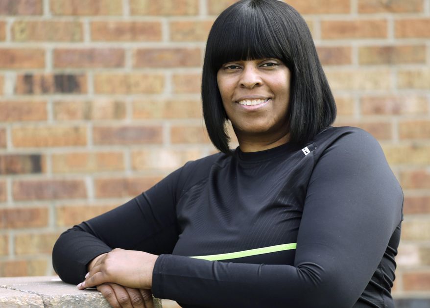 In this April 16, 2015 photo Mishaun Cannon, 48, poses for a portrait in Markham, Ill. Cannon unexpectedly lost a good-paying hospital job last year and has been pursuing a career-switch master’s degree, signed up for Medicaid in January. She was surprised to learn she likely would qualify for food stamps too. (AP Photo/M. Spencer Green)