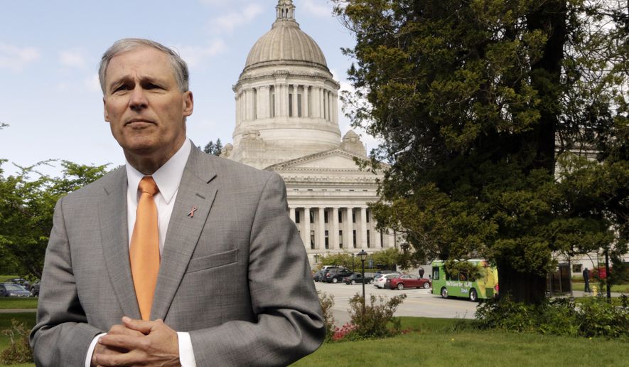 Washington Gov. Jay Inslee talks to the media on Earth Day, Wednesday, April 22, 2015, in Olympia, Wash. Inslee says that the upcoming special session should be used to advance an environment-friendly agenda. Inslee said the extended lawmaking session needs to result in new laws on carbon pollution, oil-train safety and toxic pollutants that show up in the state's fish. (AP Photo/Rachel La Corte)