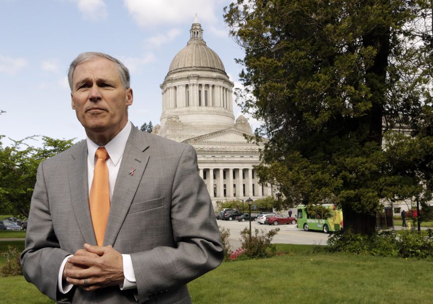 Washington Gov. Jay Inslee talks to the media on Earth Day, Wednesday, April 22, 2015, in Olympia, Wash. Inslee says that the upcoming special session should be used to advance an environment-friendly agenda. Inslee said the extended lawmaking session needs to result in new laws on carbon pollution, oil-train safety and toxic pollutants that show up in the state's fish. (AP Photo/Rachel La Corte)