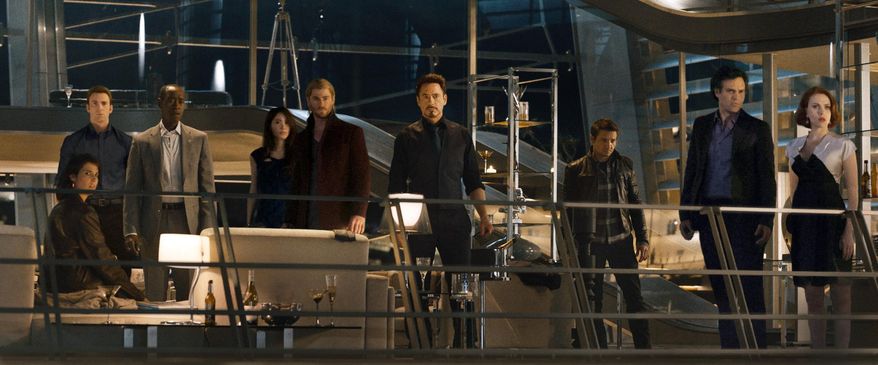 This photo provided by Disney/Marvel shows, from left, Cobie Smulders, seated, Chris Evans, Don Cheadle, Claudia Kim, Chris Hemsworth, Robert Downey Jr., Jeremy Renner, Mark Ruffalo and Scarlett Johansson in the film, "Avengers: Age Of Ultron." The movie releases in U.S. theaters on May 1, 2015. (Disney/Marvel via AP)