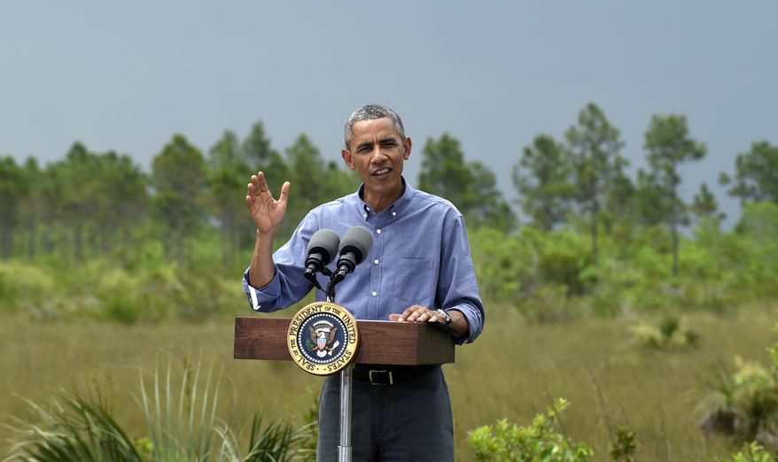 President Barack Obama speaks about Earth Day while visiting Everglades National Park, Fla., Wednesday, April 22, 2015. Obama visited the Everglades on Earth Day to talk about how global warming threatens the U.S. economy. He says rising sea levels are putting the "economic engine for the South Florida tourism industry" at risk. (AP Photo/Susan Walsh)